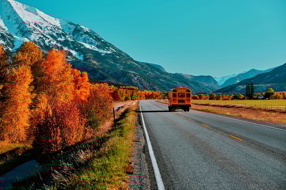 school-bus-on-highway-in-colorado-at-autumn-2021-08-26-16-19-28-utc